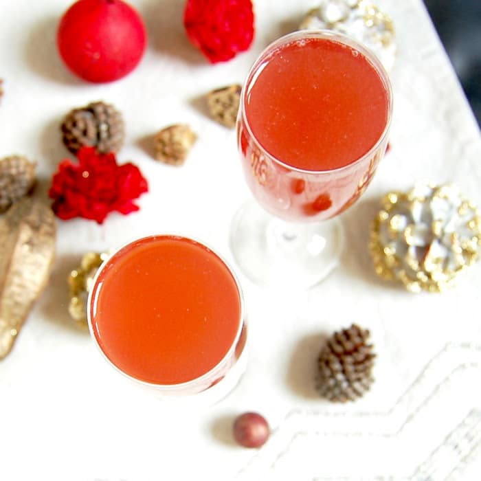 Celebrate the holiday season and ring in the New Year with a bright and festive Pomegranate French 75 cocktail with less added sugar. Recipe via JessicaLevinson.com #AD #ChampagneCocktail #NewYearsCocktail #CocktailRecipe Pomegranate French 75 Cocktail Overhead