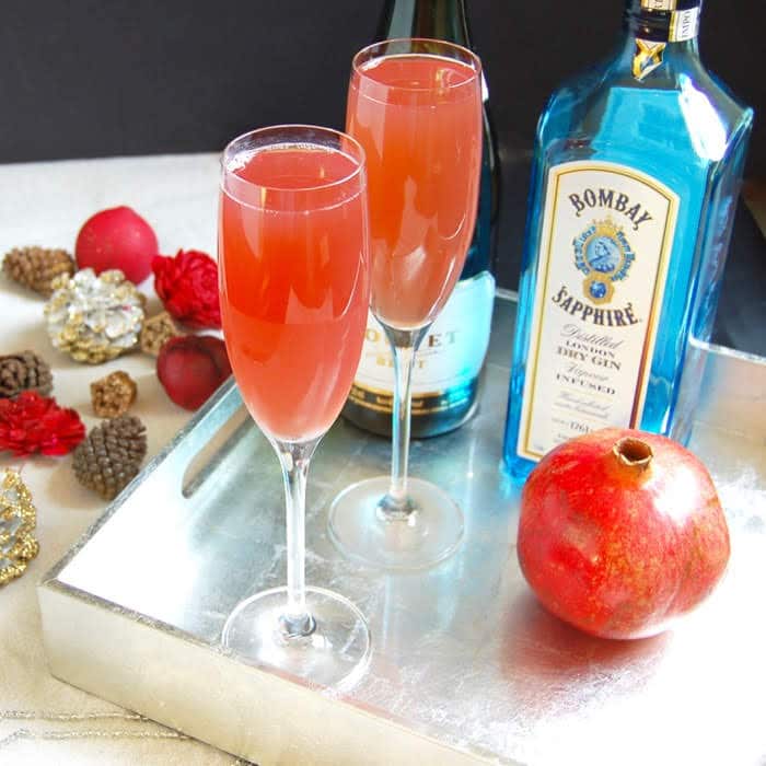 Celebrate the holiday season and ring in the New Year with a bright and festive Pomegranate French 75 cocktail with less added sugar. Recipe via JessicaLevinson.com #AD #ChampagneCocktail #NewYearsCocktail #CocktailRecipe Pomegranate French 75 Cocktail with Bombay