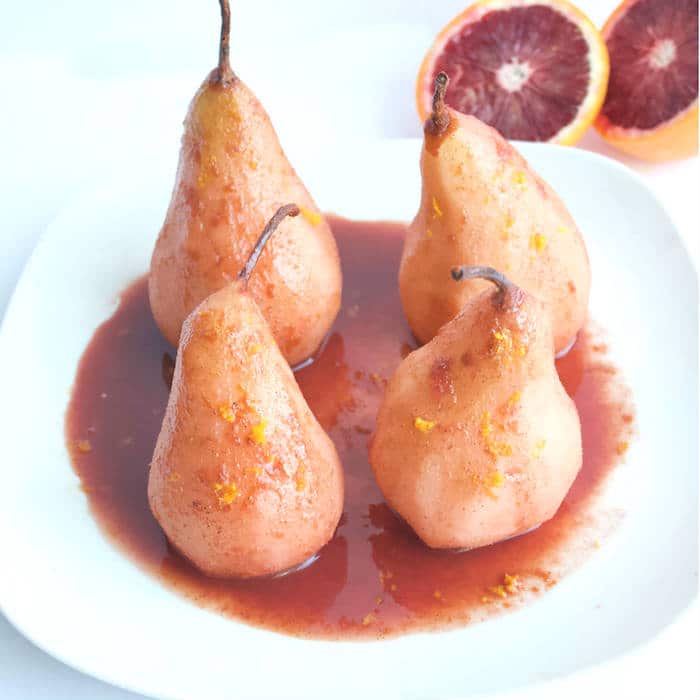 Blood Orange Poached Pears are made with only five simple ingredients, and no added sweeteners. A simple and elegant dessert for any occasion! Get the vegan and gluten-free recipe at JessicaLevinson.com | #lowsugar #winterrecipes #oranges #pears Blood Orange Poached Pears Close Up