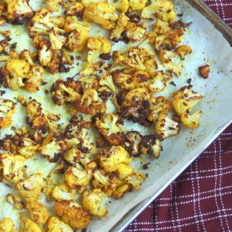 close up of roasted turmeric cauliflower on baking sheet