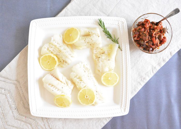 Oven Baked Cod with Rustic Sun Dried Tomato Olive Tapenade | Jessica Levinson, MS, RDN, CDN Oven Baked Cod with lemon on plate and side of olive tapenade