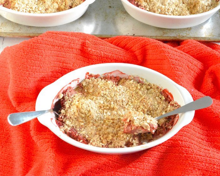 Get tips for managing added sugar this summer and enjoy a lower-sugar version of one of summer’s quintessential desserts, Strawberry Rhubarb Crisp (AD). Recipe via JessicaLevinson.com | #addedsugar #lowsugardessert #strawberry #rhubarb #summerdessert #splendanaturals Strawberry Rhubarb Crisp in Dish with Two Spoons