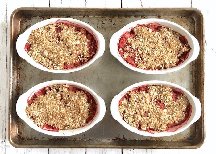 Get tips for managing added sugar this summer and enjoy a lower-sugar version of one of summer’s quintessential desserts, Strawberry Rhubarb Crisp (AD). Recipe via JessicaLevinson.com | #addedsugar #lowsugardessert #strawberry #rhubarb #summerdessert #splendanaturals Strawberry Rhubarb Crisp on Baking Tray