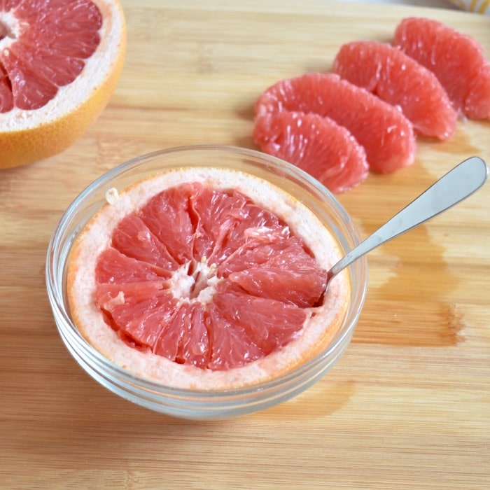 Enjoy grapefruit cut in half Enjoy grapefruit cut in half and eaten by spoon