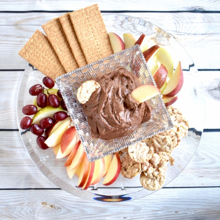 chocolate peanut dessert hummus with fruit, graham crackers, and popcorn cakes fruit dipped chocolate hummus